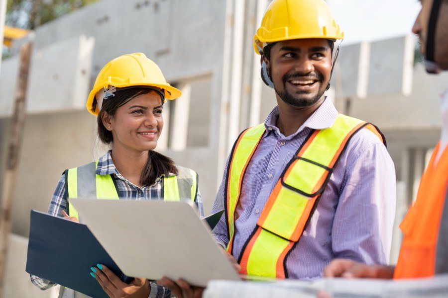 Indian foremen reviewing drawings on site