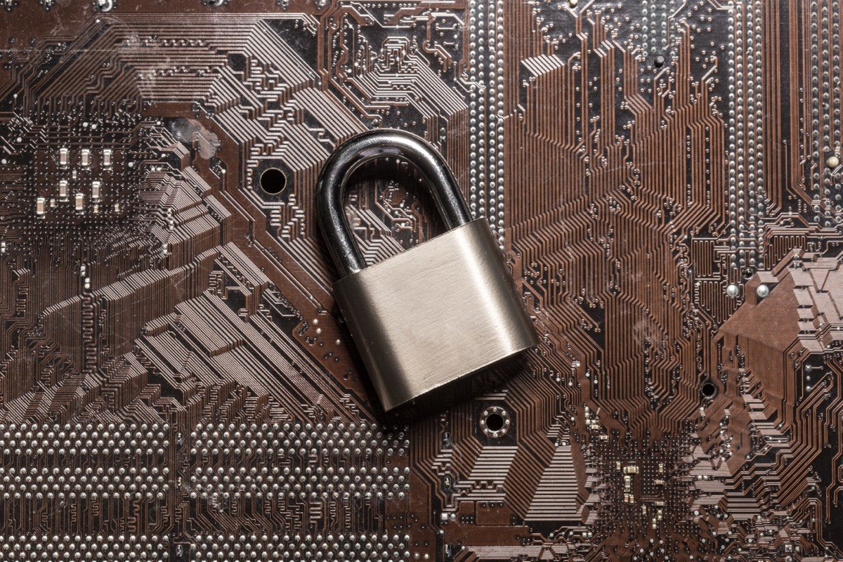 A padlock resting on a circuit board