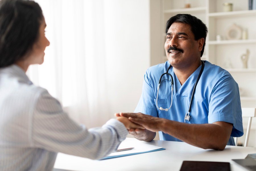 An Indian doctor reassuring a patient