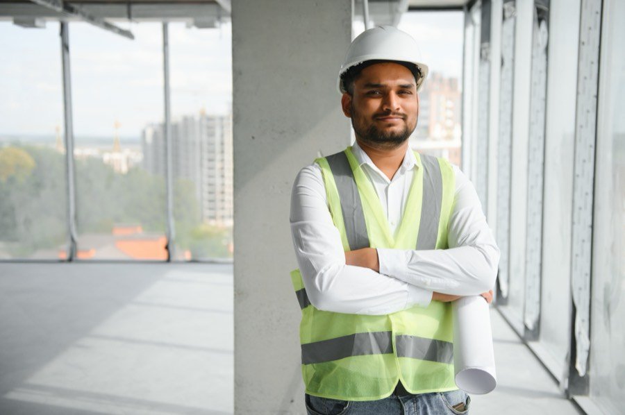 An Indian site engineer in safety gear