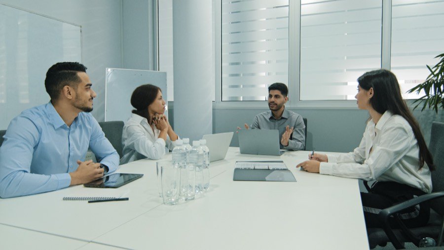 An Indian team leader in a benefits review meeting