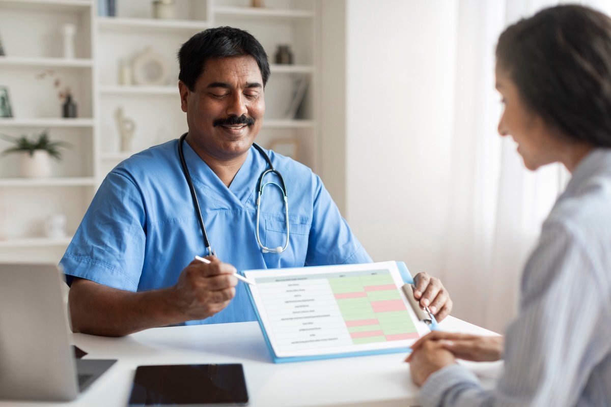 An Indian doctor discussing test results with a patient